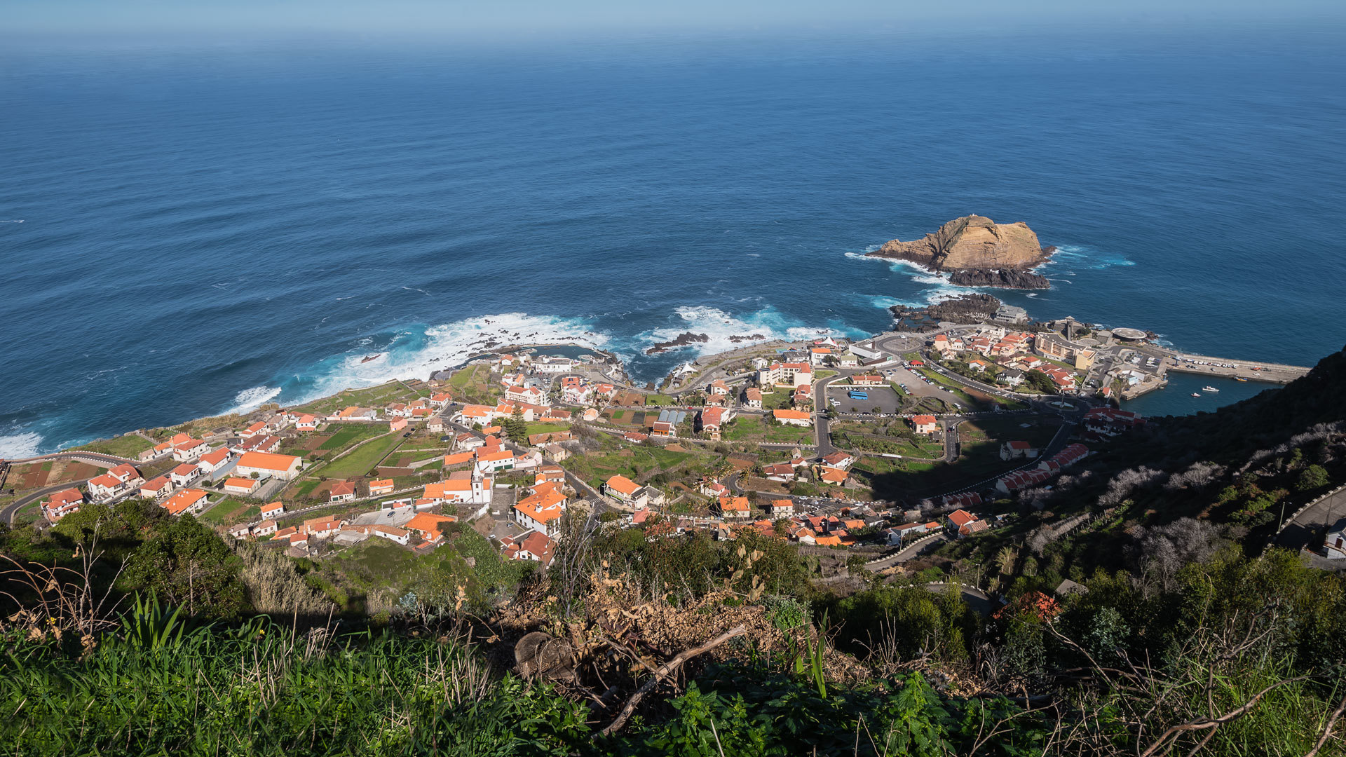 Houses on hillside with sea view in Madeira.