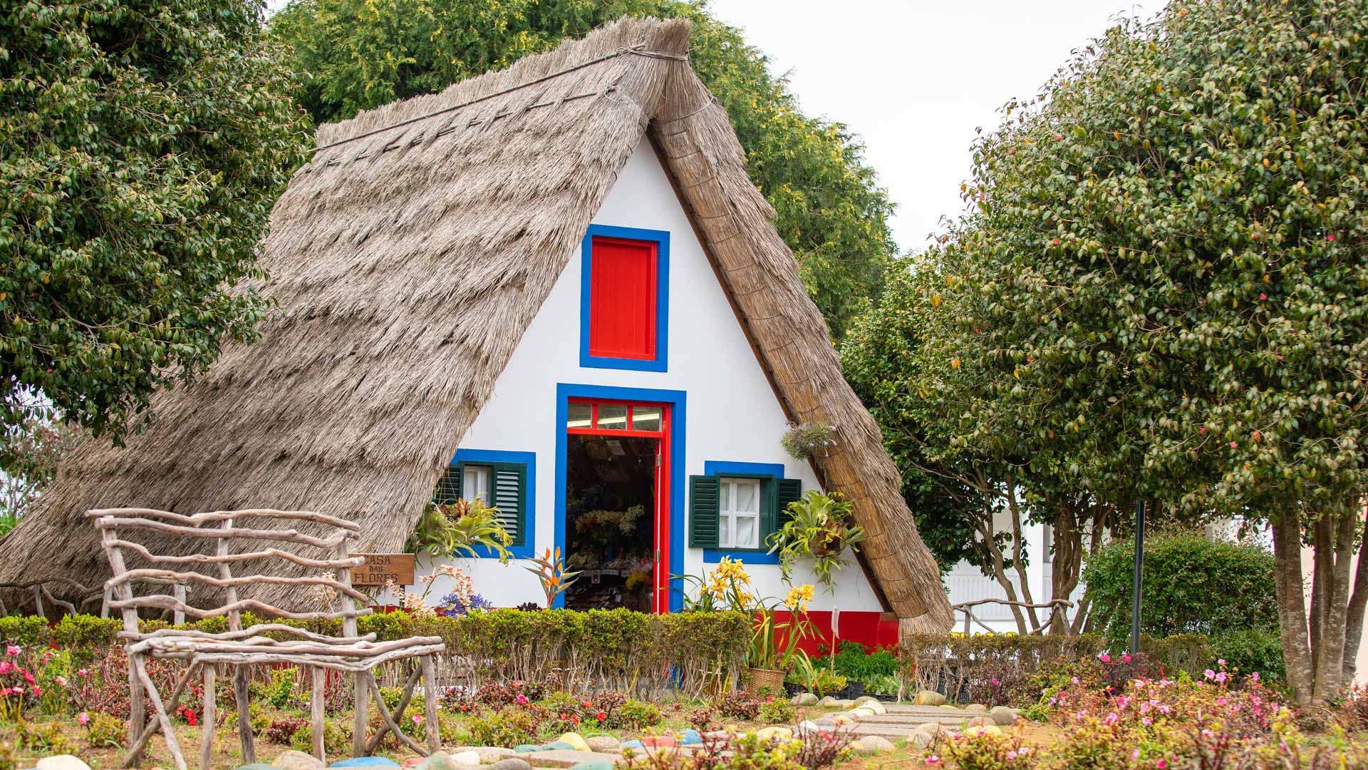 Triangular house with traditional thatched roof in Madeira.