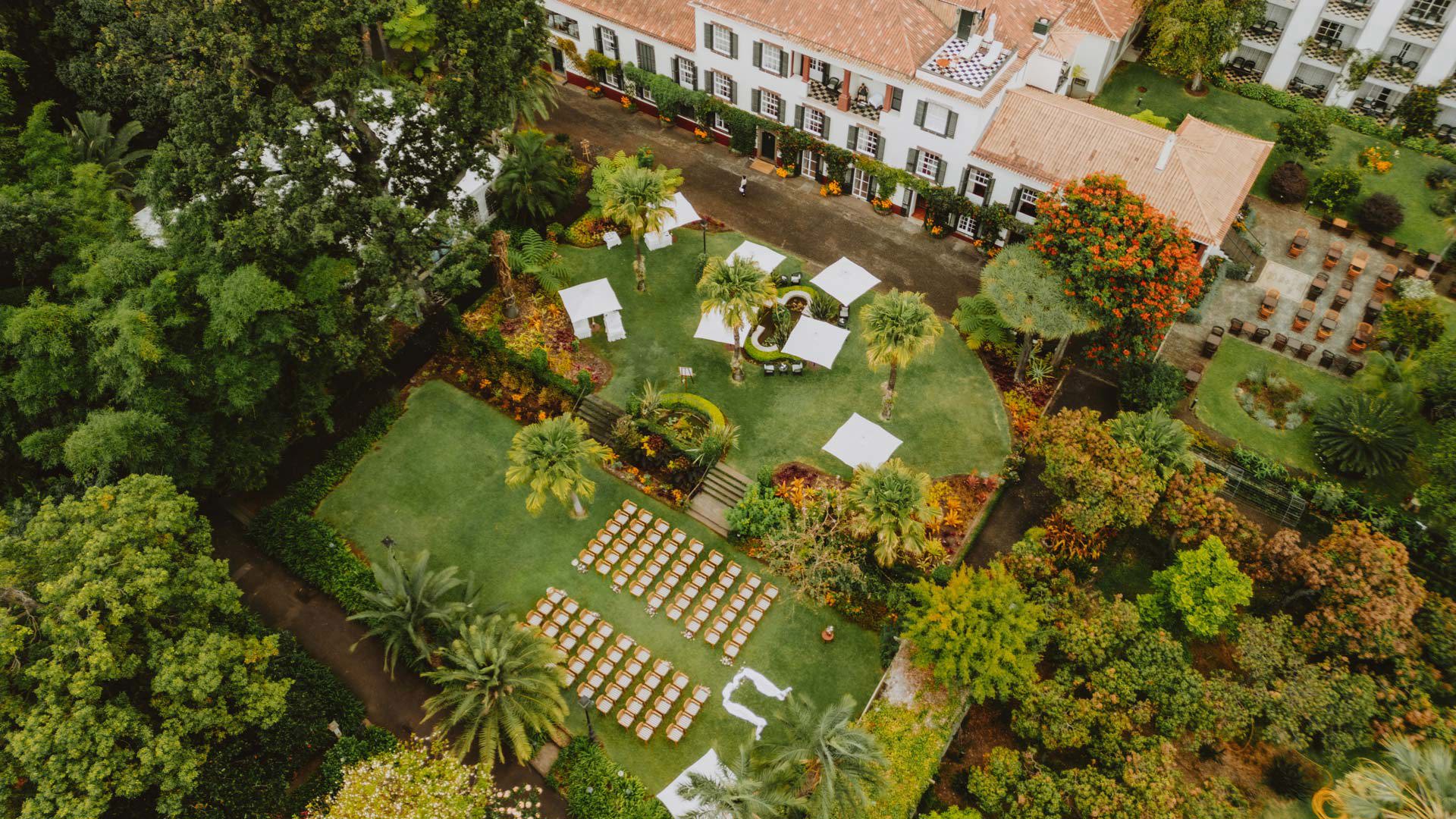 Aerial view of outdoor wedding ceremony space with chairs and nature.