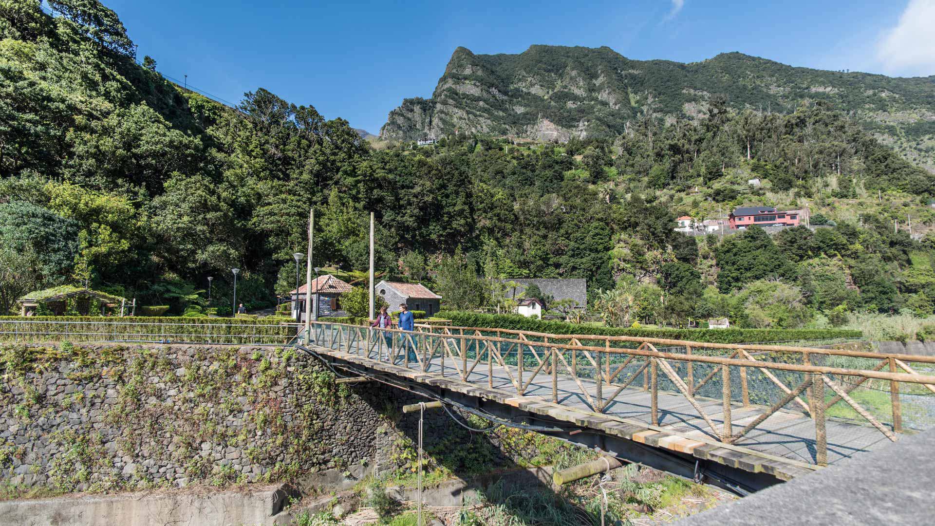 Wooden bridge with mountain in the background.