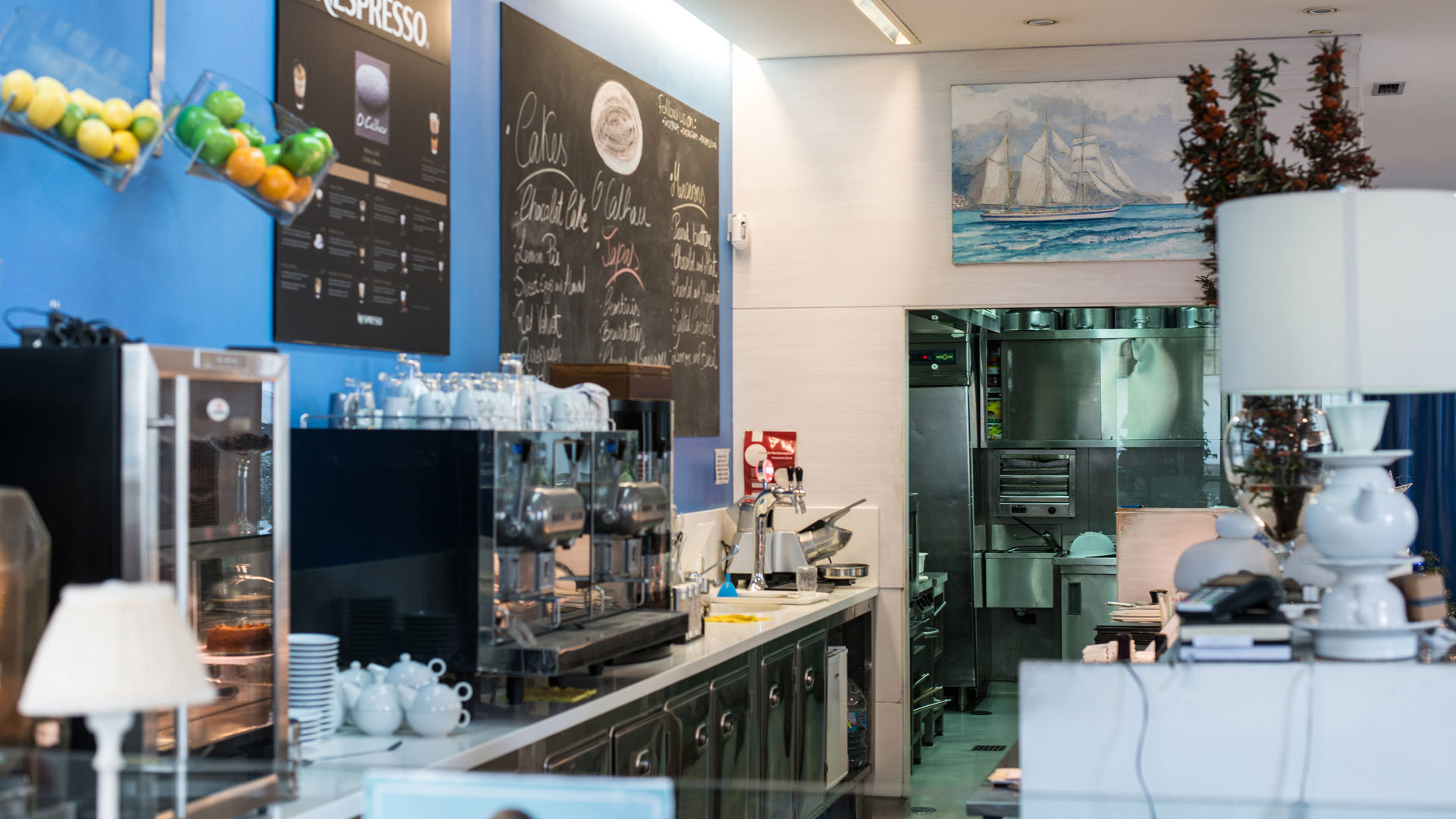 Restaurant counter with coffee machine and lamp.