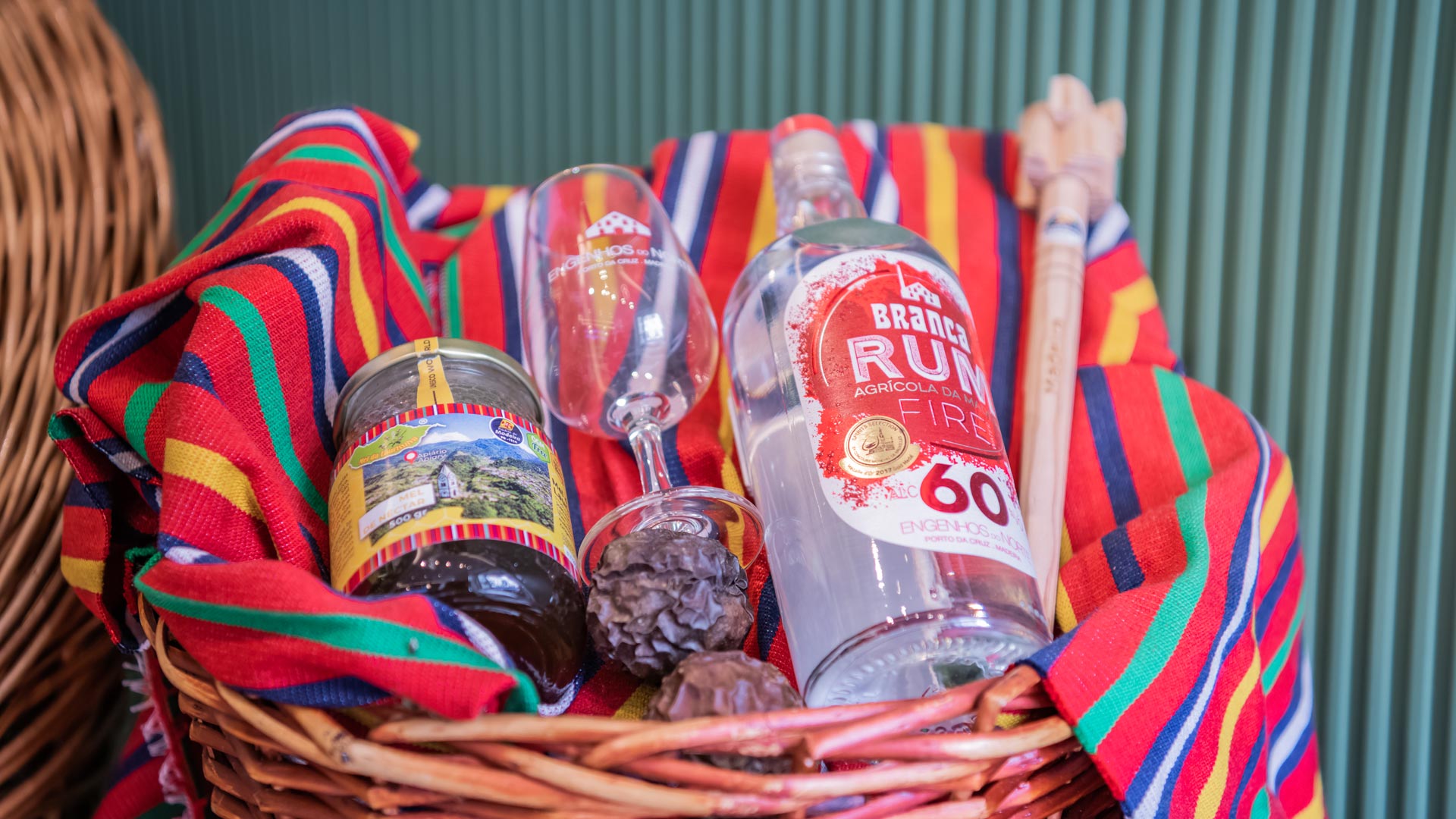 Wicker basket with rum, honey, and glasses at the Madeira Tourism Office in Lisbon.