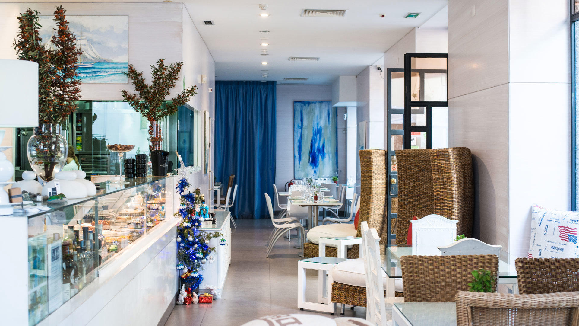 Restaurant mit Schaufenster und Tischen am Eingang.