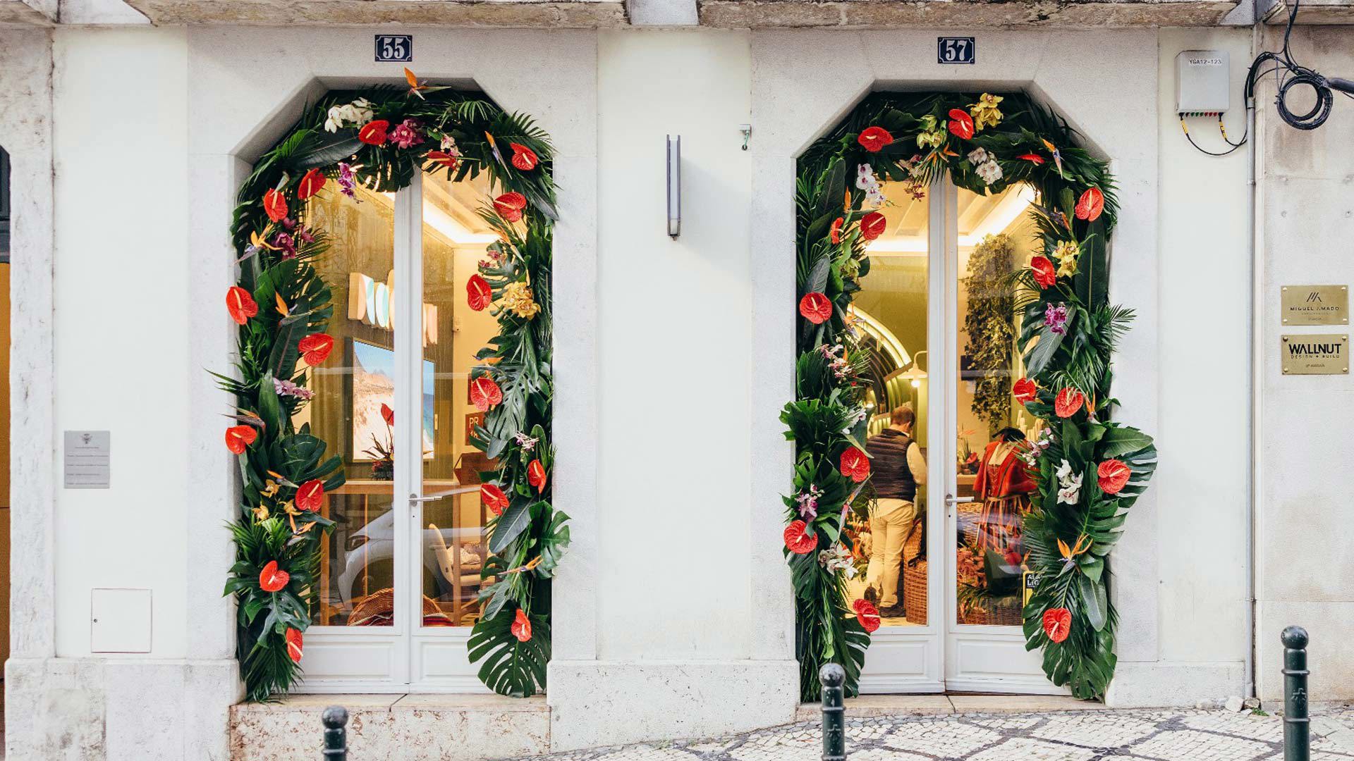 Exterior of the Madeira Tourism Office in Lisbon with flower arches on the windows.