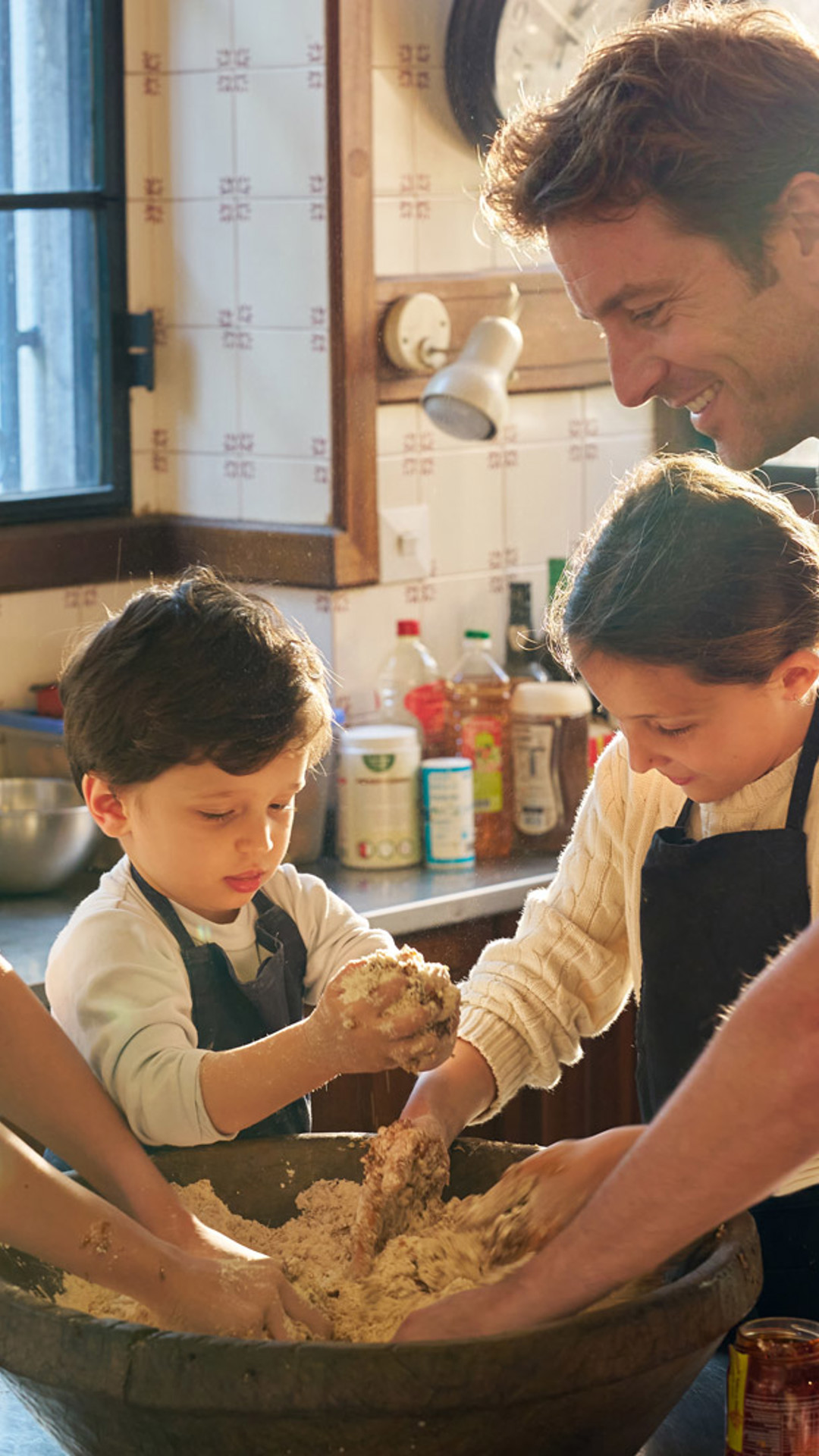 Family preparing bolo de mel dough, a tradition from Madeira Island.