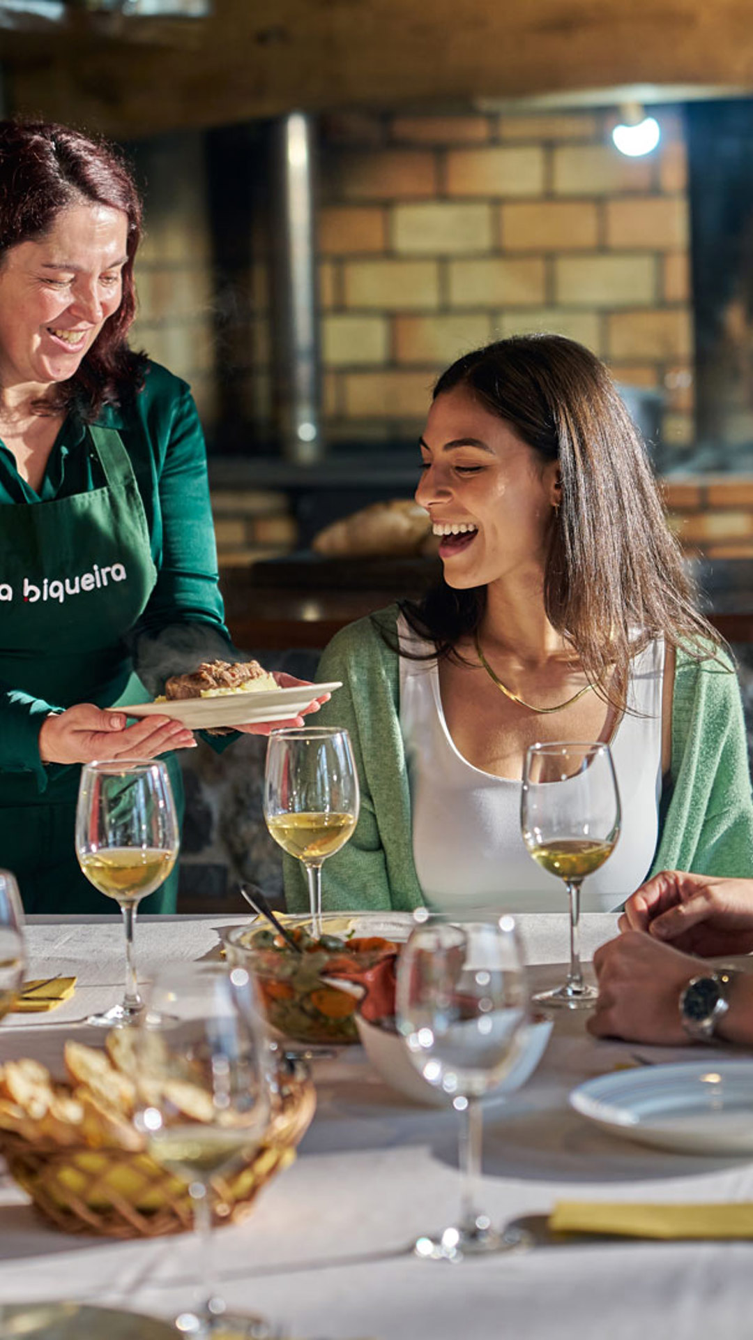 People socialising during a meal at a restaurant on Madeira Island.