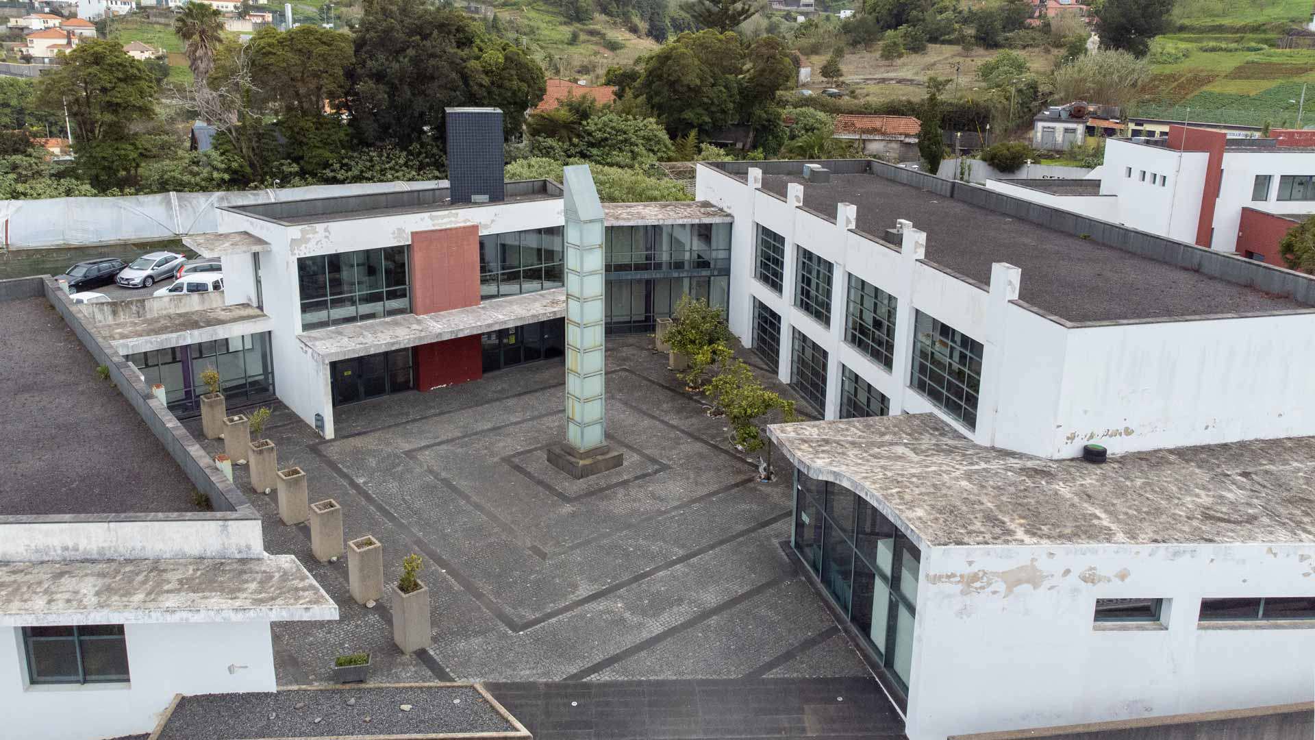 Old buildings with a glass structure in the middle.