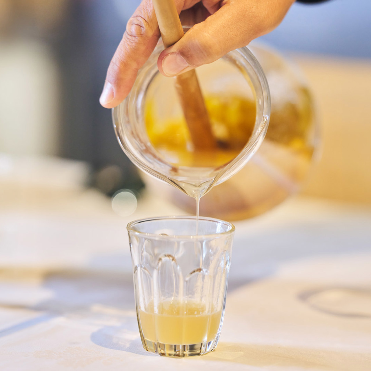 Poncha being poured from a jug into a glass on Madeira Island.