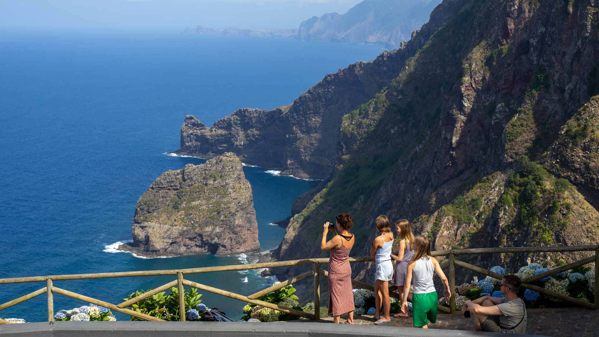 People taking photos of the landscape with a sea view in Madeira.