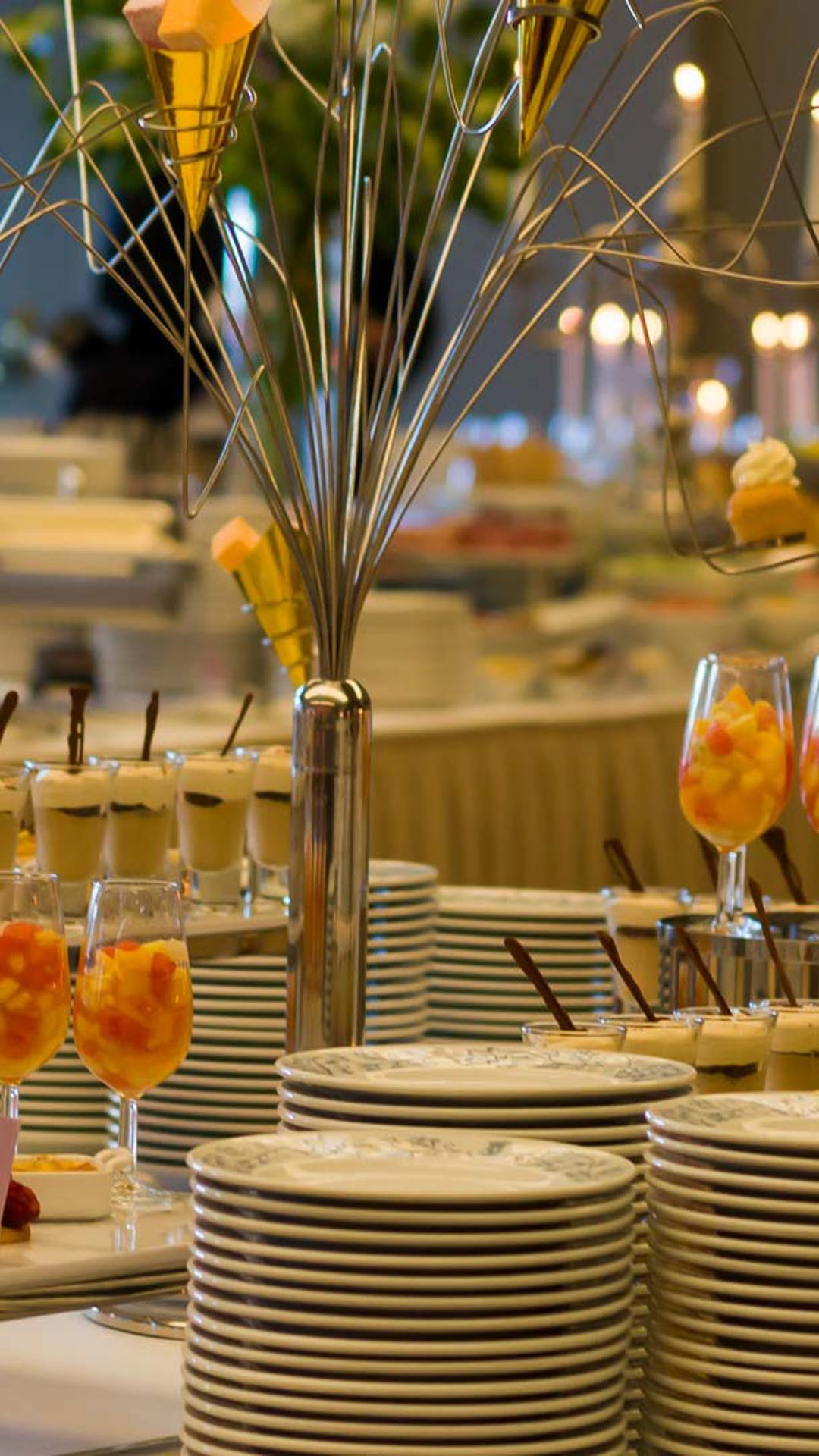 Dishes with dessert options on a buffet table for a ceremony.