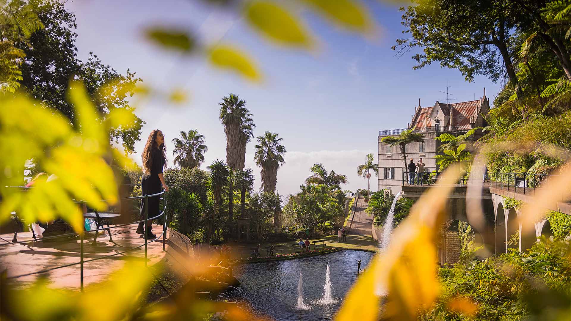 Lake at Monte Palace Tropical Garden Madeira surrounded by lush vegetation.