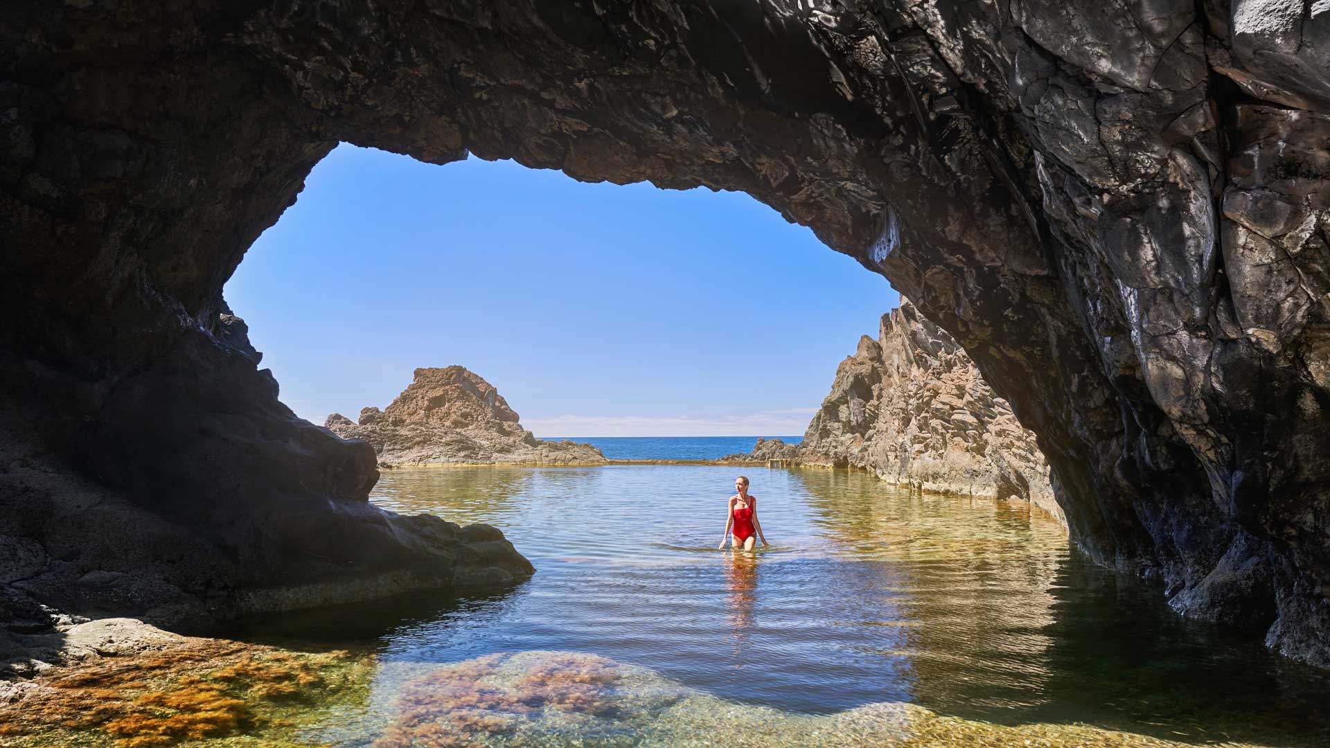 Mujer con bikini rojo en la piscina natural de Madeira.