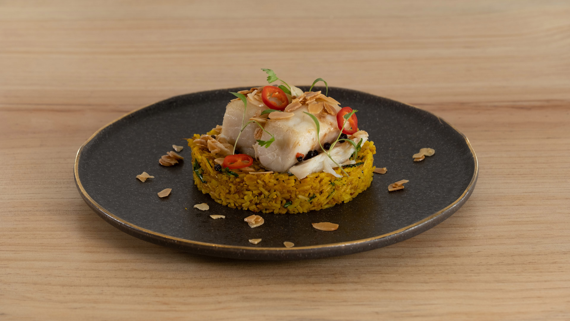 Plate with rice base topped with codfish.