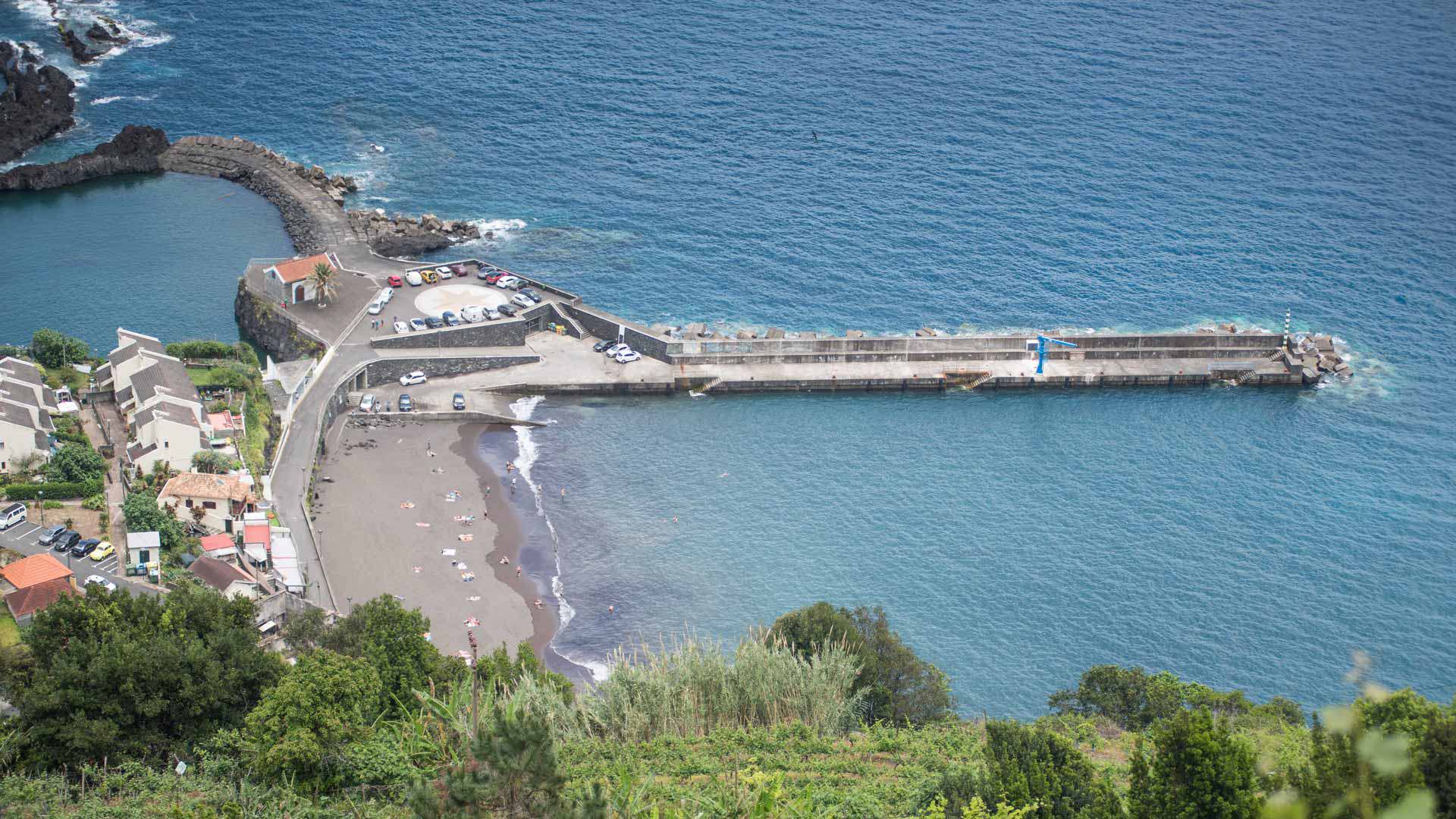 Aerial view of Seixal Beach with pier and beach area in Madeira.