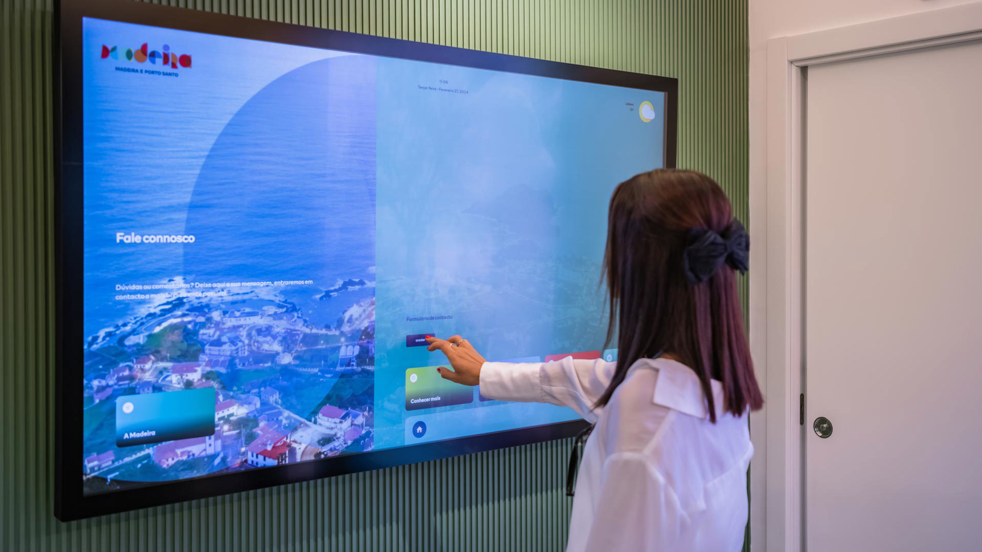 Woman consulting an information board at the Madeira Tourism Office in Lisbon.