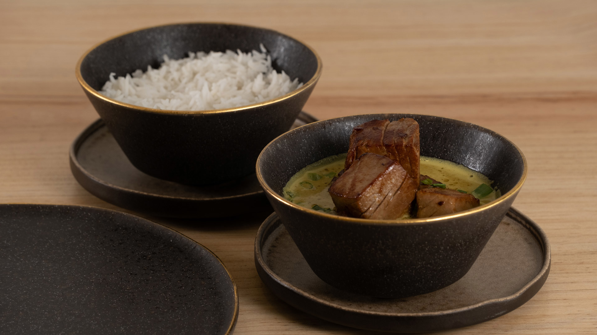 Bowls with rice and meat served.
