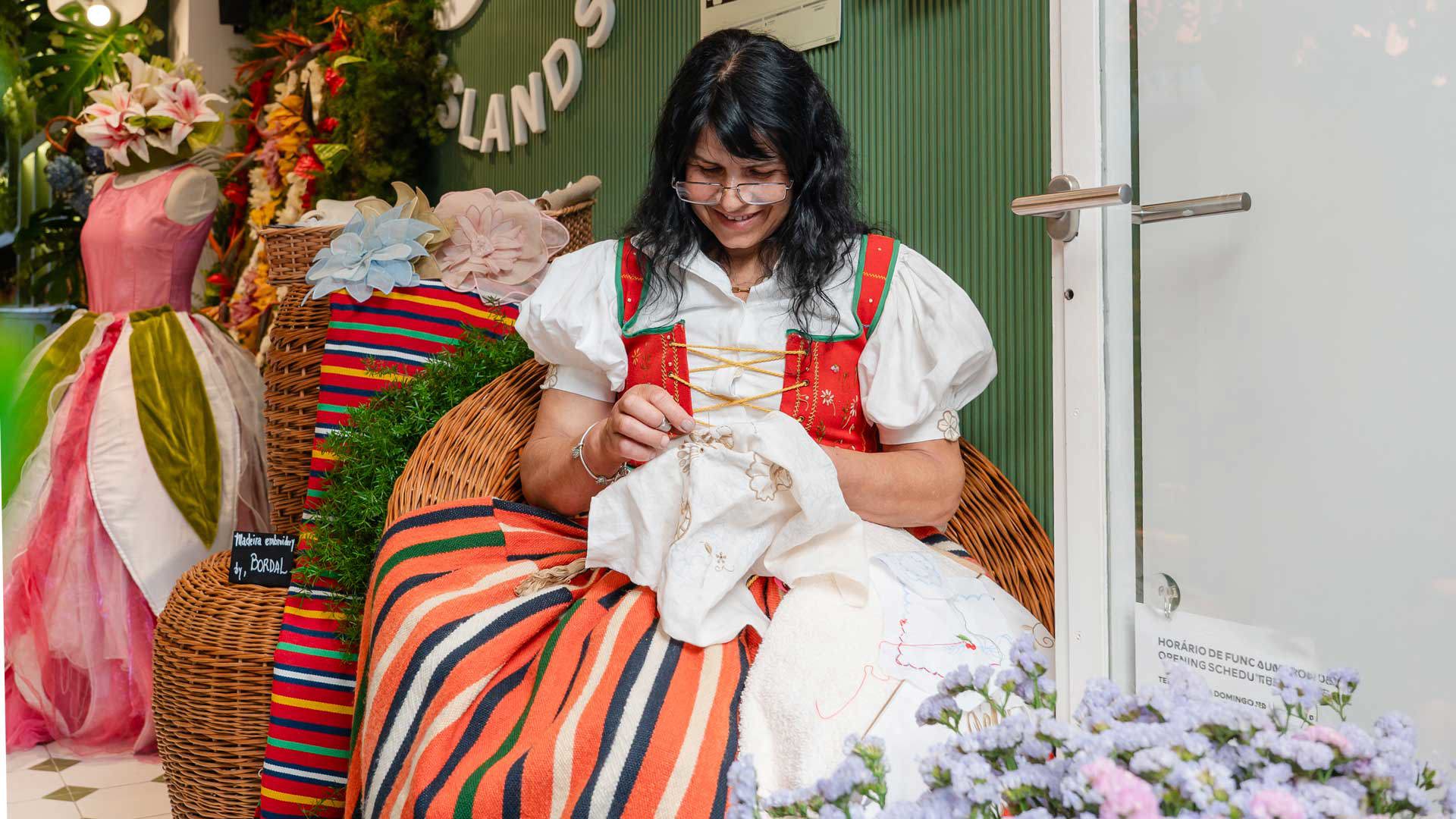 Woman in traditional folk costume embroidering.