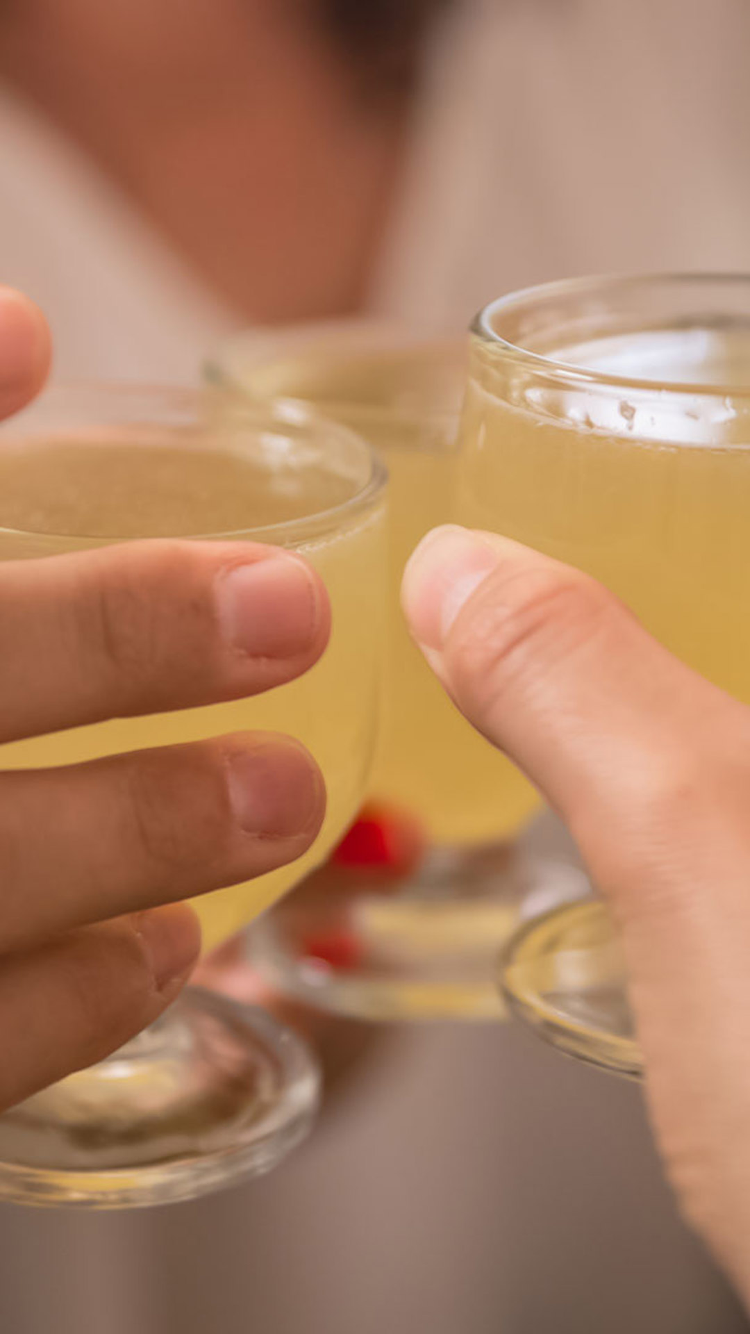 Toast with fisherman’s poncha, hands raising glasses on Madeira Island.