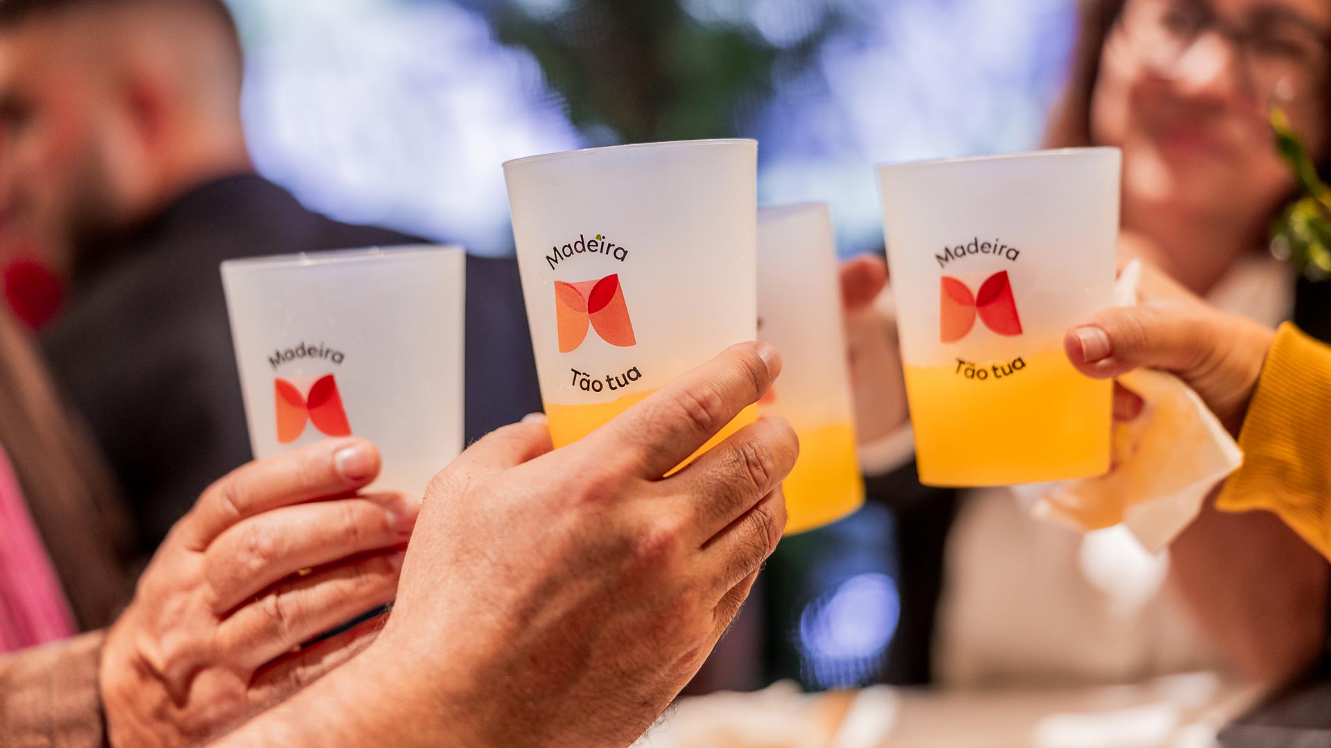 Glasses of poncha making a toast at the Madeira Tourism Office in Lisbon.