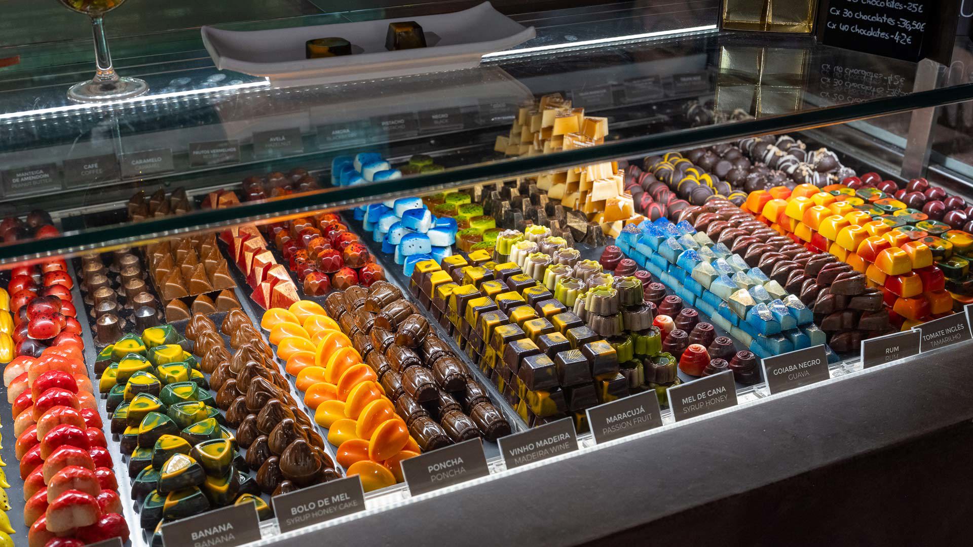Display window with colorful fruit-flavored chocolates at the Chocolate Market, Madeira tourist information office in Lisbon.